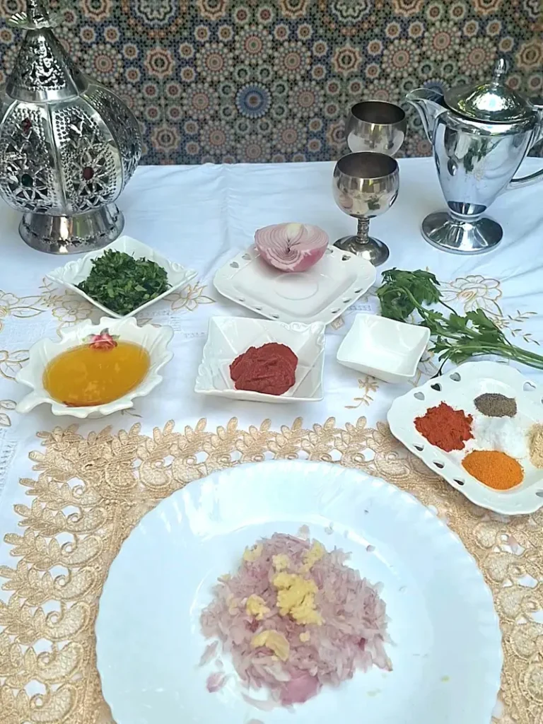 Ingredients for One-Pot Moroccan Lentils (Adass) including fresh crushed garlic, olive oil, and vibrant spices like turmeric and paprika.